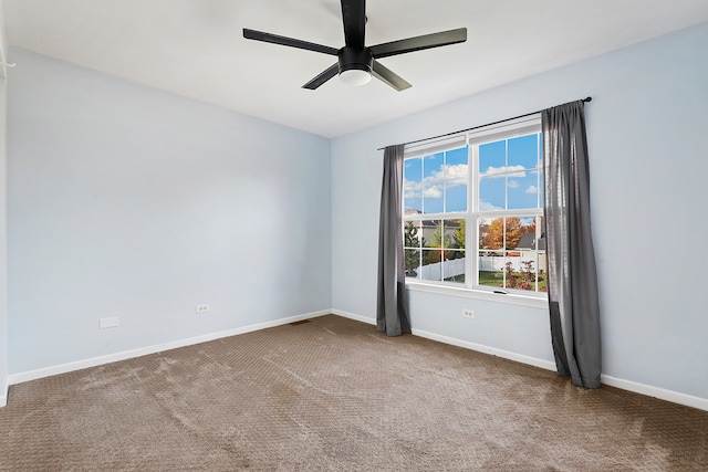 carpeted empty room featuring ceiling fan