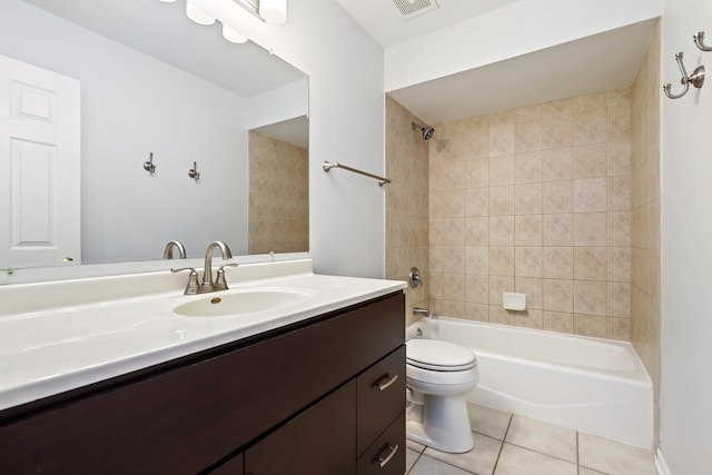 full bathroom featuring tiled shower / bath, vanity, toilet, and tile patterned flooring