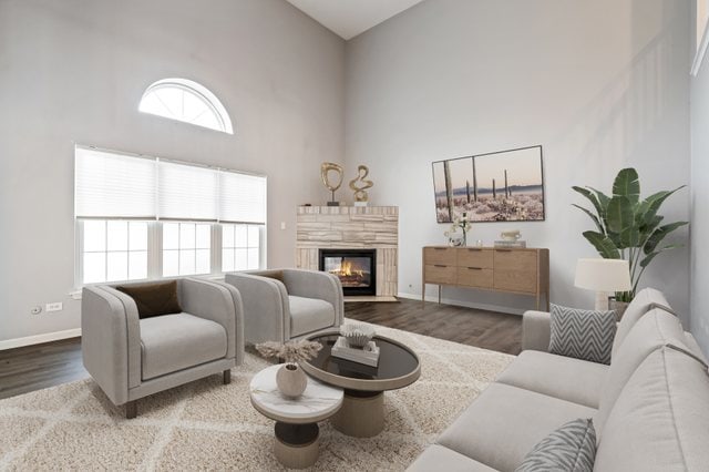 living room with hardwood / wood-style flooring and a towering ceiling