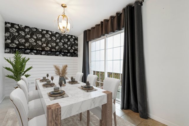 tiled dining room featuring a notable chandelier