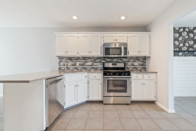 kitchen featuring white cabinetry, kitchen peninsula, and stainless steel appliances