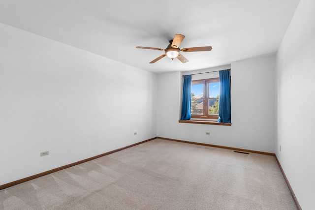 carpeted spare room with ceiling fan