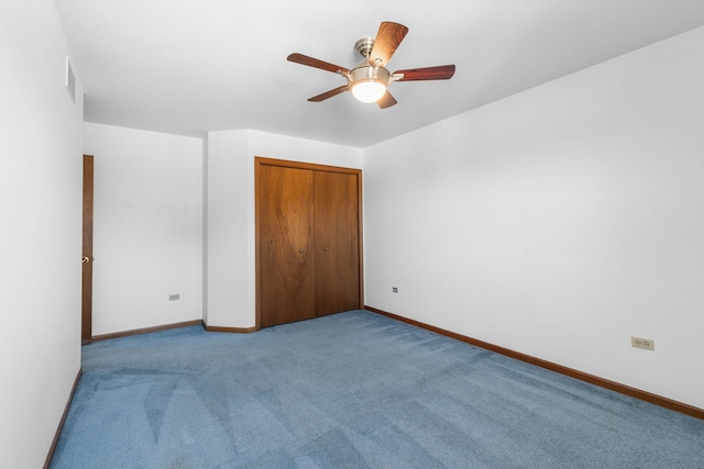 unfurnished bedroom with light carpet, ceiling fan, and a closet