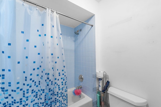 bathroom with shower / tub combo and toilet