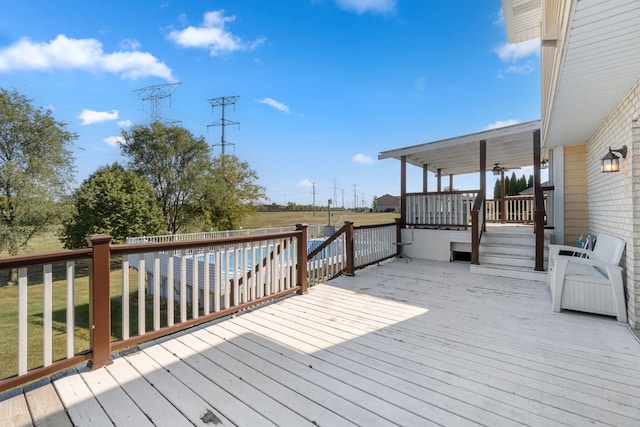 wooden deck featuring a lawn