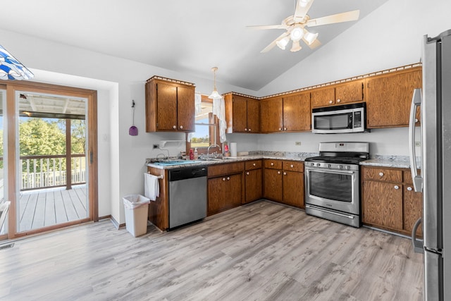 kitchen featuring light hardwood / wood-style floors, sink, high vaulted ceiling, appliances with stainless steel finishes, and ceiling fan