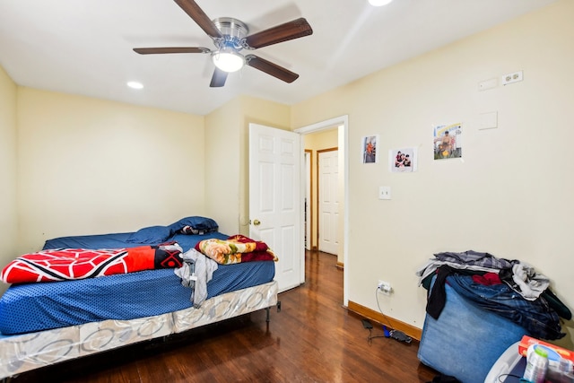 bedroom with dark hardwood / wood-style floors and ceiling fan