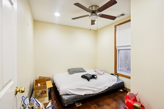 bedroom with ceiling fan and dark hardwood / wood-style flooring