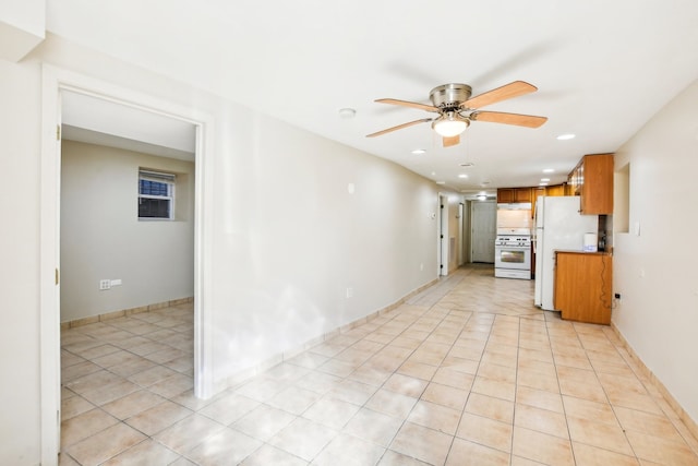 interior space with ceiling fan and light tile patterned flooring