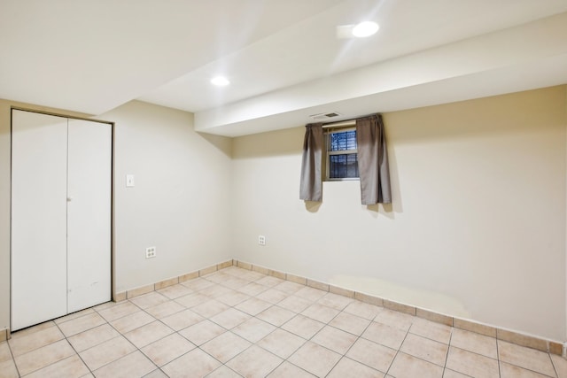 basement featuring light tile patterned floors