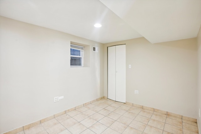 unfurnished room with light tile patterned floors