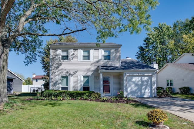 view of front of property featuring a front yard and a garage