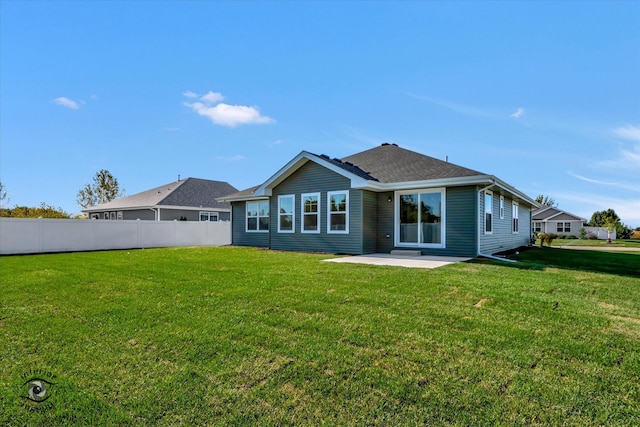 back of house with a yard and a patio area