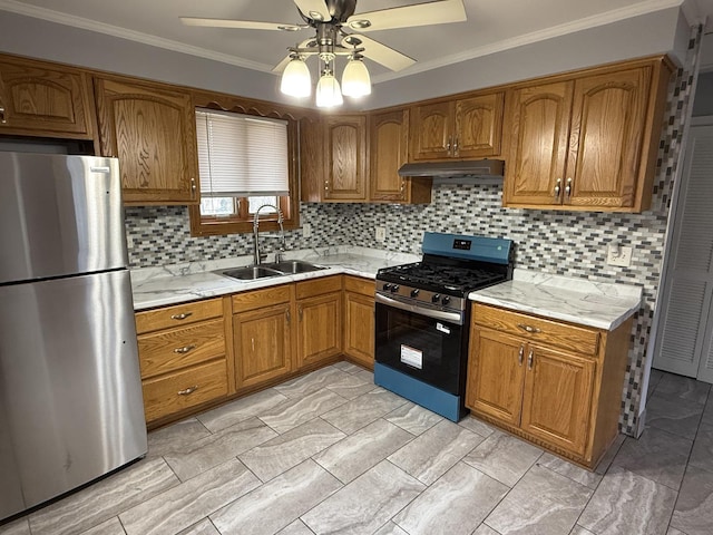 kitchen featuring a sink, brown cabinetry, under cabinet range hood, ceiling fan, and appliances with stainless steel finishes