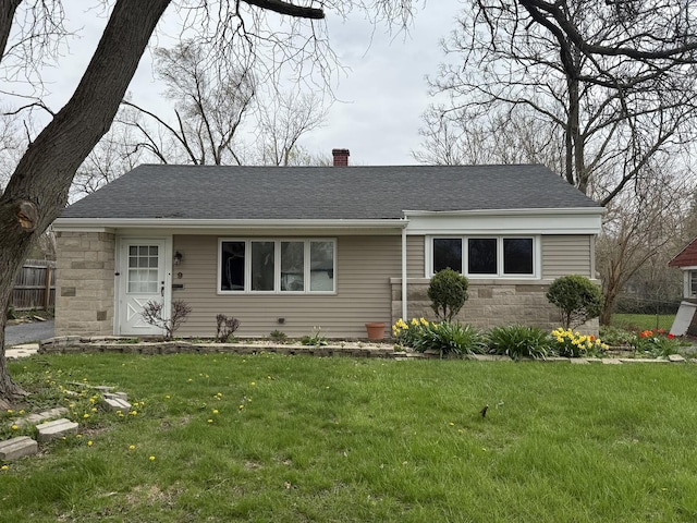 ranch-style home featuring a chimney, fence, roof with shingles, and a front yard