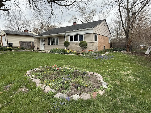 single story home featuring a chimney, a front yard, and fence