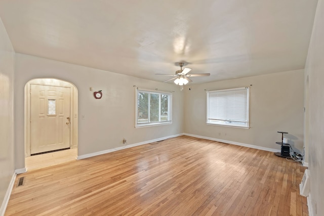 unfurnished living room featuring ceiling fan and light hardwood / wood-style floors