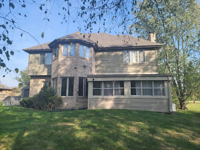 back of house with a lawn