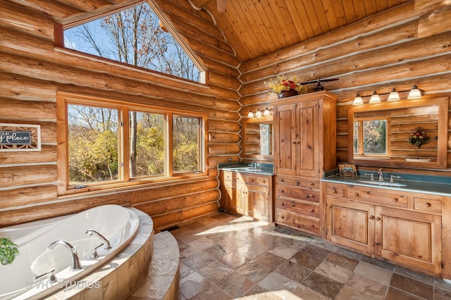 bathroom with vaulted ceiling, wood ceiling, a bathing tub, vanity, and log walls