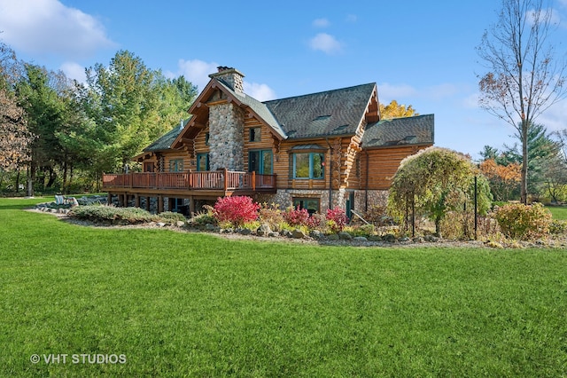 rear view of property with a yard and a wooden deck