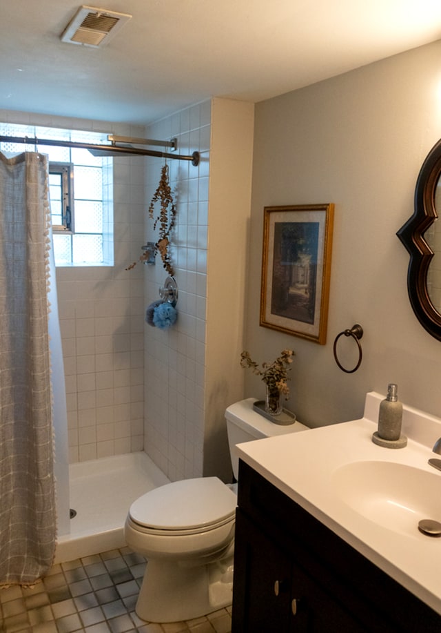 bathroom featuring a shower with curtain, tile patterned flooring, vanity, and toilet