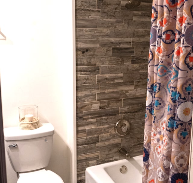 bathroom featuring shower / bath combo and toilet