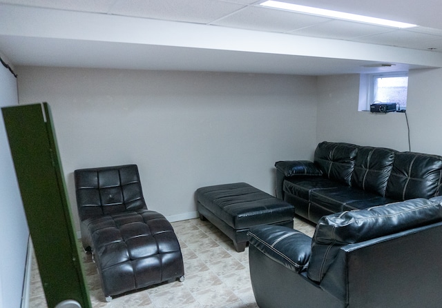 living room featuring a paneled ceiling