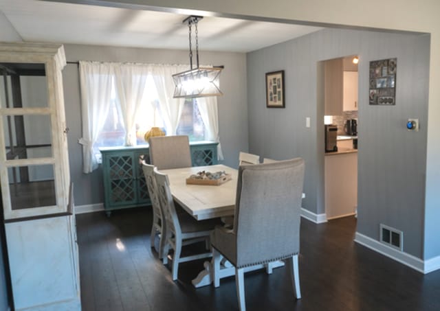 dining area featuring dark wood-type flooring