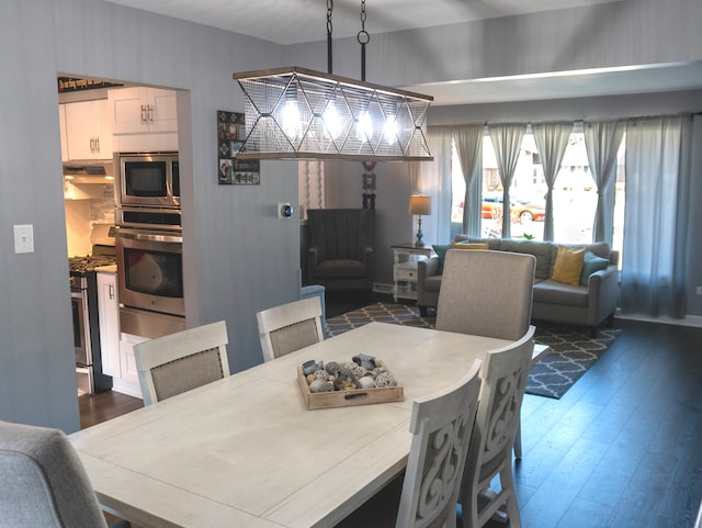 dining space with dark hardwood / wood-style flooring