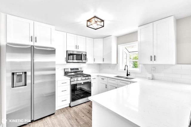 9036 Walnut Ave, Franklin Park, IL 60131 - kitchen with appliances with stainless steel finishes, a sink, white cabinetry, light wood-style flooring, and decorative backsplash