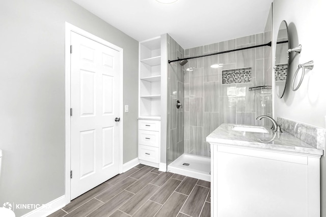9036 Walnut Ave, Franklin Park, IL 60131 - bathroom with tiled shower, vanity, wood finish floors, and baseboards