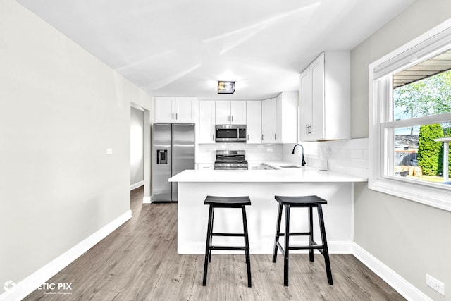 9036 Walnut Ave, Franklin Park, IL 60131 - kitchen with appliances with stainless steel finishes, a sink, light countertops, and backsplash
