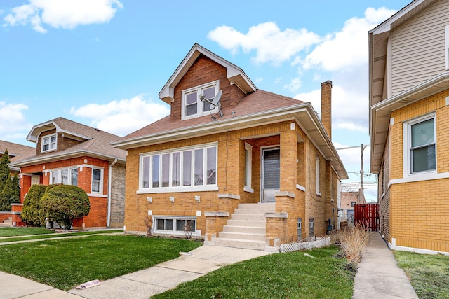 bungalow-style home featuring brick siding, a front lawn, and fence