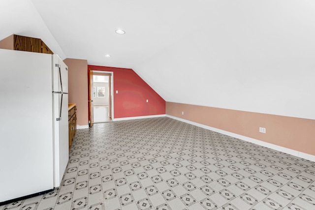 bonus room with lofted ceiling, baseboards, and recessed lighting