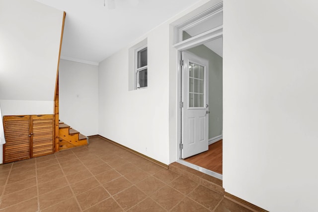 additional living space featuring tile patterned flooring, stairs, and baseboards