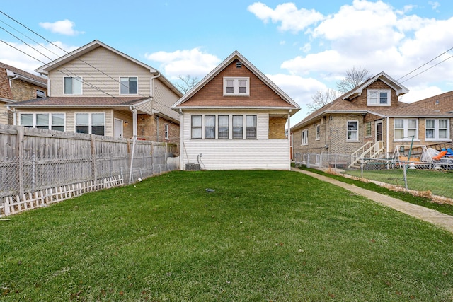 rear view of property featuring a lawn, cooling unit, and a fenced backyard