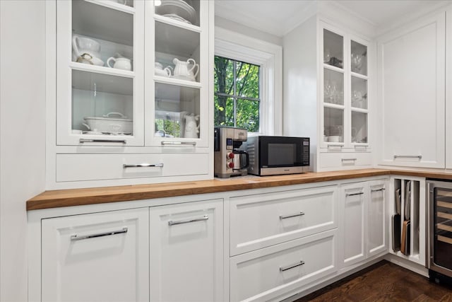 bar with dark wood-type flooring, butcher block counters, and white cabinetry