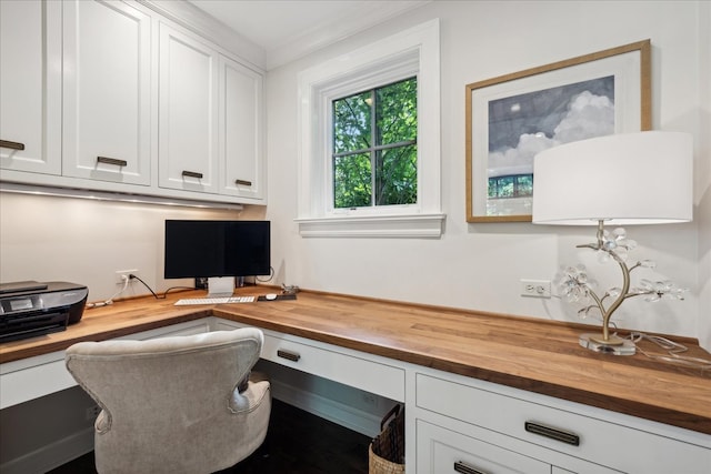 office with built in desk and crown molding