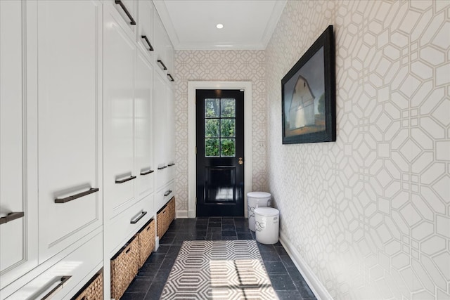 mudroom with ornamental molding and a barn door