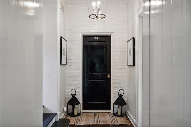 interior space featuring brick wall and dark hardwood / wood-style flooring