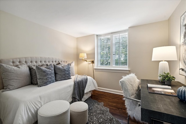 bedroom with dark hardwood / wood-style flooring