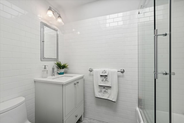 bathroom with vanity, an enclosed shower, and toilet