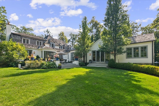 back of property featuring a lawn