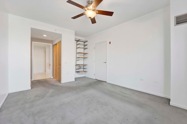 unfurnished bedroom featuring light carpet, a closet, and ceiling fan