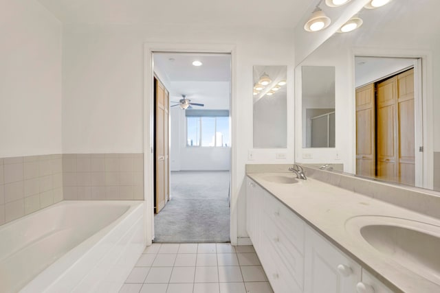 bathroom with ceiling fan, vanity, plus walk in shower, and tile patterned flooring