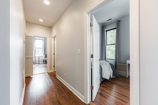 corridor featuring dark hardwood / wood-style floors