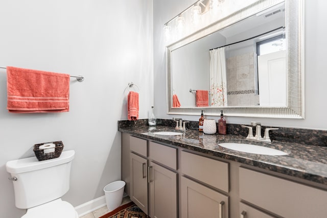 bathroom featuring walk in shower, vanity, toilet, and tile patterned floors