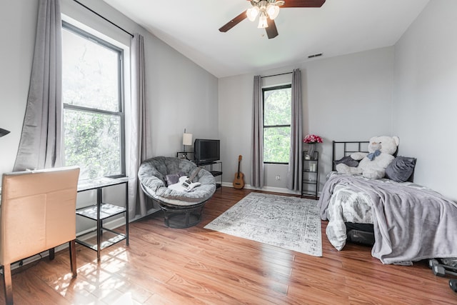 bedroom featuring lofted ceiling, light hardwood / wood-style floors, and ceiling fan