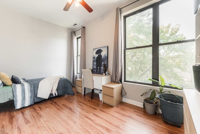 bedroom with ceiling fan and light wood-type flooring