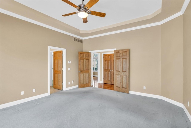 1709 Brighton Ct, Champaign, IL 61822 - unfurnished bedroom with carpet floors, baseboards, a high ceiling, a tray ceiling, and ornamental molding
